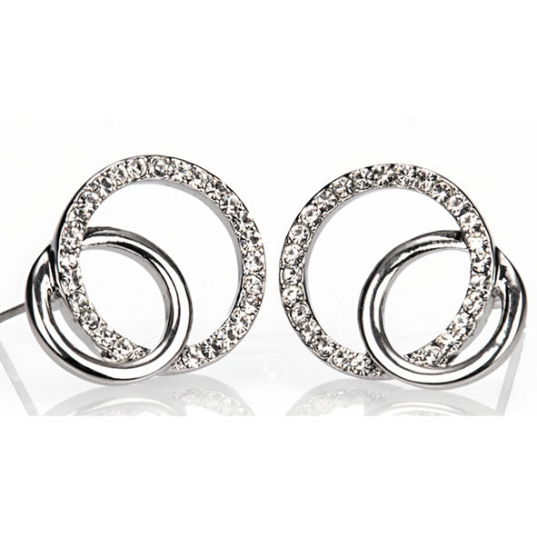 A pair of silver-colored diamante loop earrings on a white background.