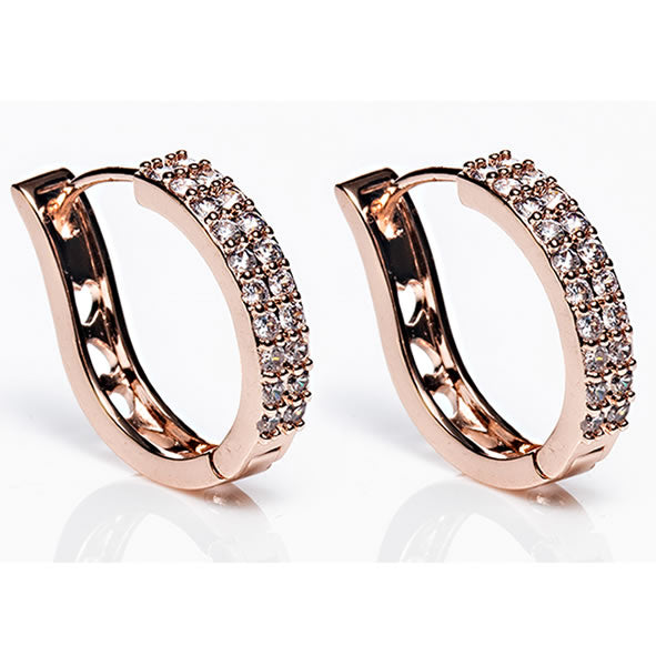 A pair of rose gold-colored large hoop earrings adorned with diamantés, presented against a white background.