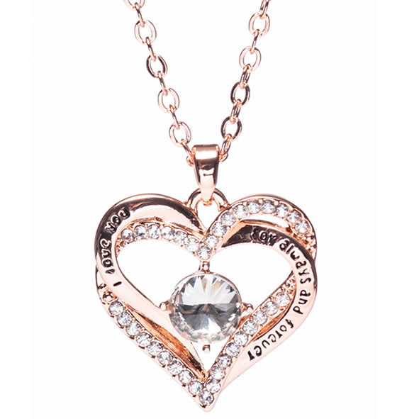 A rose gold heart-shaped pendant necklace with a stone in the center and embellished with small crystals around the edge, displayed against a white background.