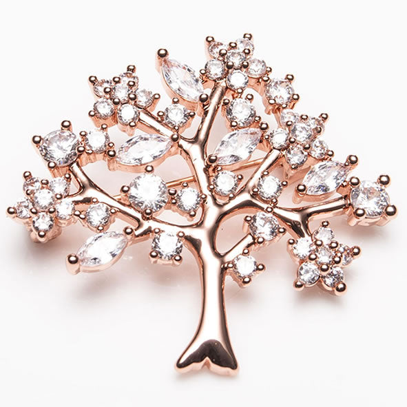 A rose gold brooch in the shape of a tree with a branching pattern, adorned with clear crystals.