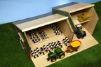Model farm with animals, tractors, and a barn on a grassy surface.