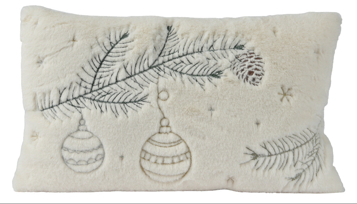 Decorative pillow with embroidered Christmas tree branches and ornaments on a white background