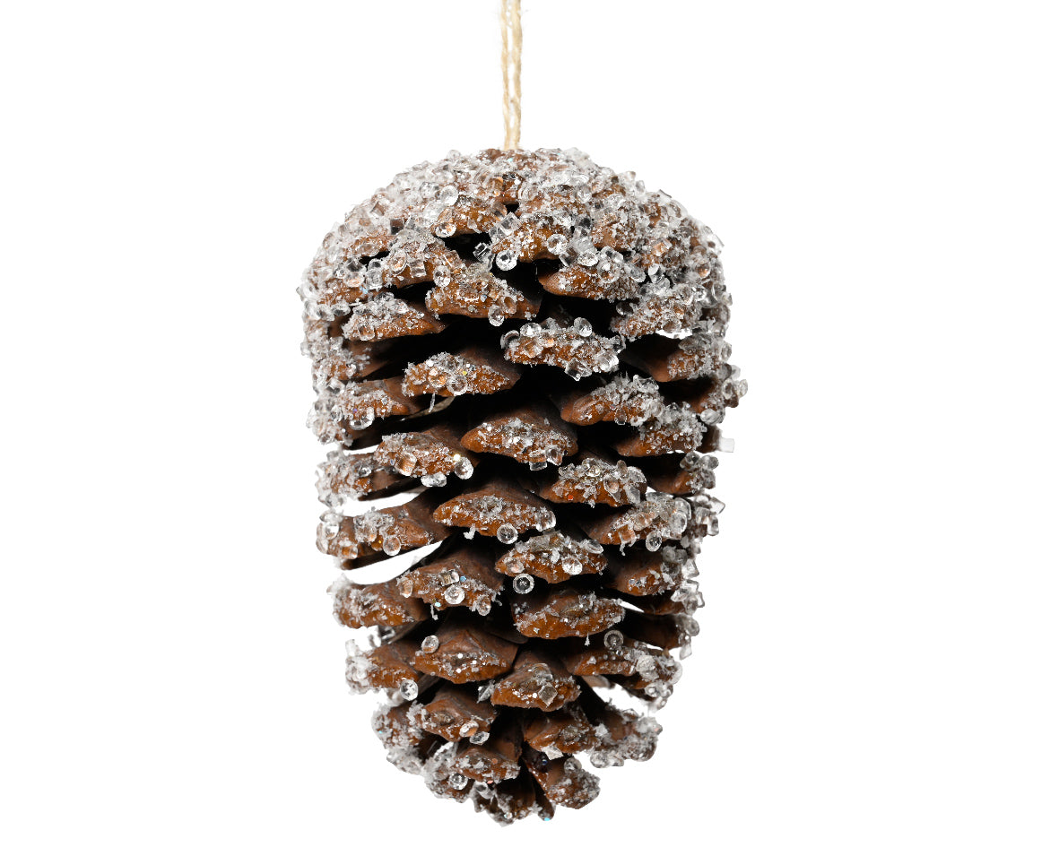 Decorative pine cone ornament with glitter on a white background