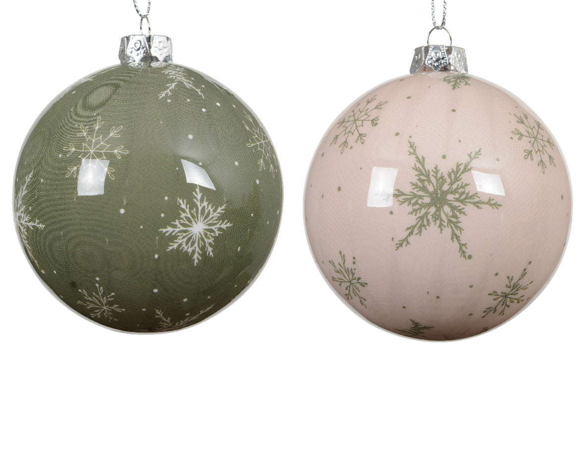 Two Christmas ornaments with snowflake designs on a white background