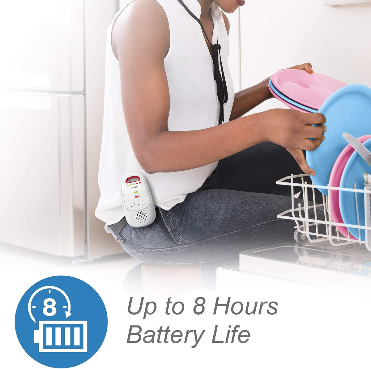 Person using a handheld device with a battery indicator, sitting next to a dish rack with colorful plates.