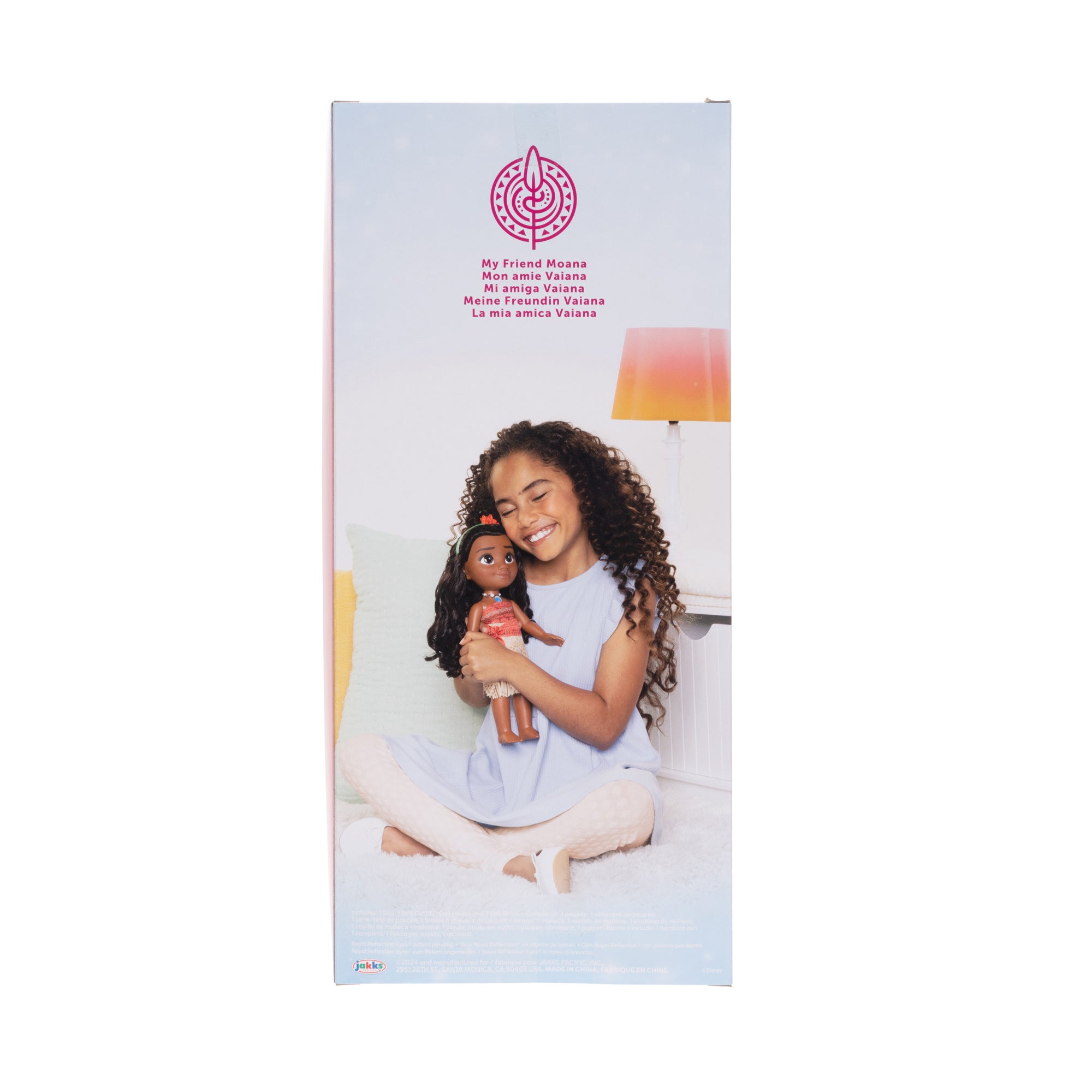 Product packaging for a doll with a girl holding it, featuring a brand logo on a white background.