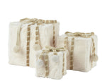 Set of three decorative boxes with textured surfaces and plaid patterns on a white background