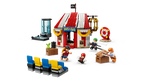 LEGO set with a circus-themed building, performers, and audience chairs on a white background