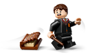 LEGO minifigure of a man in a suit with a tray of pastries on a white background
