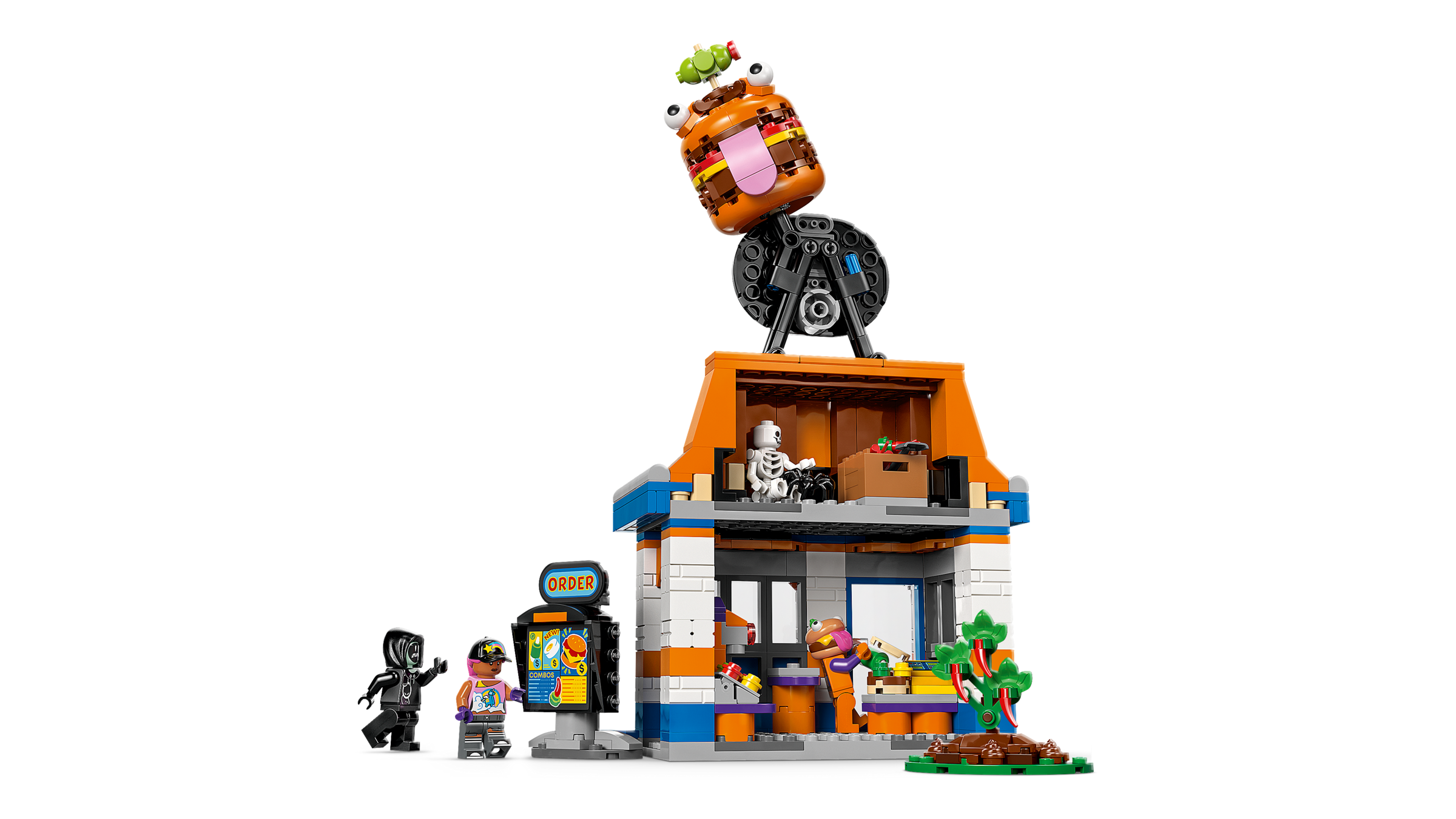 LEGO set with a small building, characters, and a vehicle on top against a white background