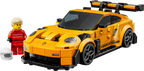 LEGO model of a sports car with a figure in a red outfit and helmet on a white background