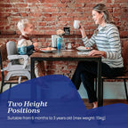 A woman and a young child sit at a wooden table in front of a brick wall, with the child using a high chair. A blue text overlay at the bottom reads 'Two Height Positions' and 'Suitable from 6 months to 3 years old (max weight: 15kg)'.