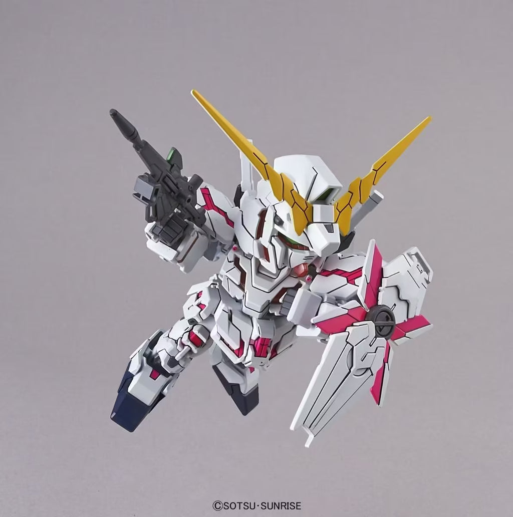 Model kit of a robot with white, yellow, and red colors on a gray background