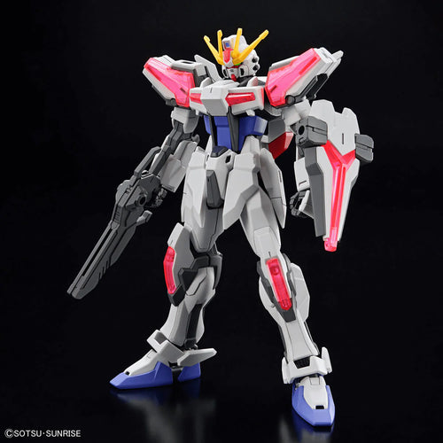Model kit of a Gundam with red, white, and blue colors on a black background