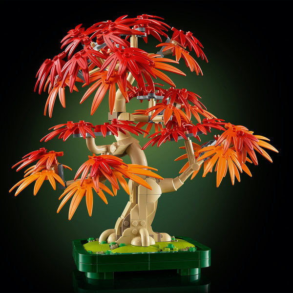 LEGO bonsai tree with red and orange leaves on a dark background