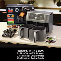 Ninja food processor with its accessories and packaging displayed on a kitchen counter, featuring a black and gray processor, three clear containers, and a Ninja-branded box. A text overlay at the bottom reads 'WHAT'S IN THE BOX'.