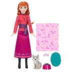 Frozen doll with accessories including a dog, patterned blanket, and items on a white background