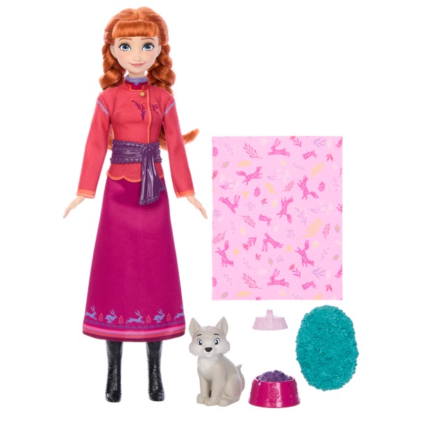 Frozen doll with accessories including a dog, patterned blanket, and items on a white background