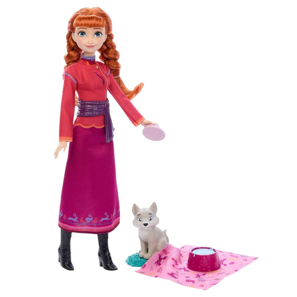 Doll in a red and purple dress with a small dog and pink blanket on a white background