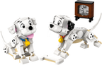 Two toy dogs made of interlocking bricks with a small TV in the background.