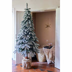 Snow‑tipped Tora Pine artificial Christmas tree, realistic PVC needles with snowy finish, perfect for festive décor.
