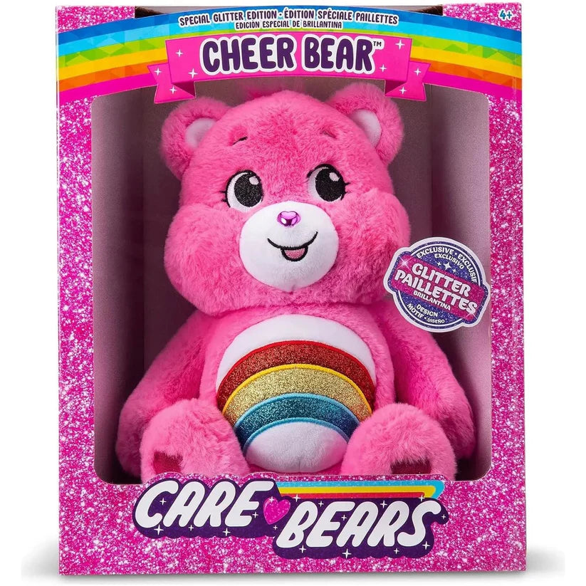 Pink plush bear toy with rainbow inside packaging, labeled 'Cheer Bear' from Care Bears series.