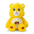 Yellow plush bear toy with a smiling face and heart details on a white background