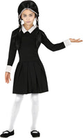 Child wearing a black and white costume with a dress and pigtails on a white background