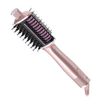 Rose gold hair styling brush with pink bristle head on a white background