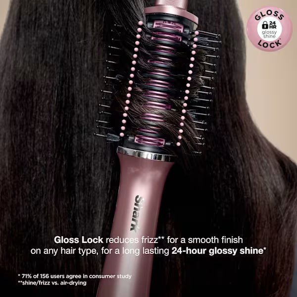 Pink hair dryer with brush attachment being used on dark hair, featuring the 'Gloss Lock' technology.