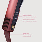 Hair styling tool with airflow and temperature controls on a light gray background