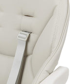Close-up of a beige Nosh highchair with a harness