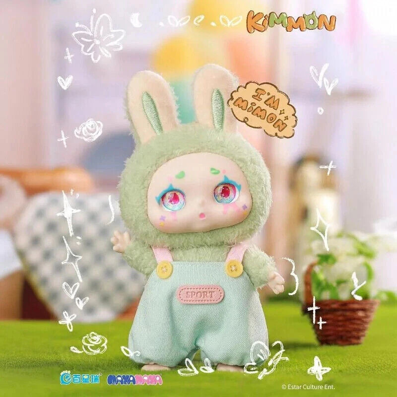 Toy figure in a green outfit with bunny ears, standing on a grassy surface with a blurred background.