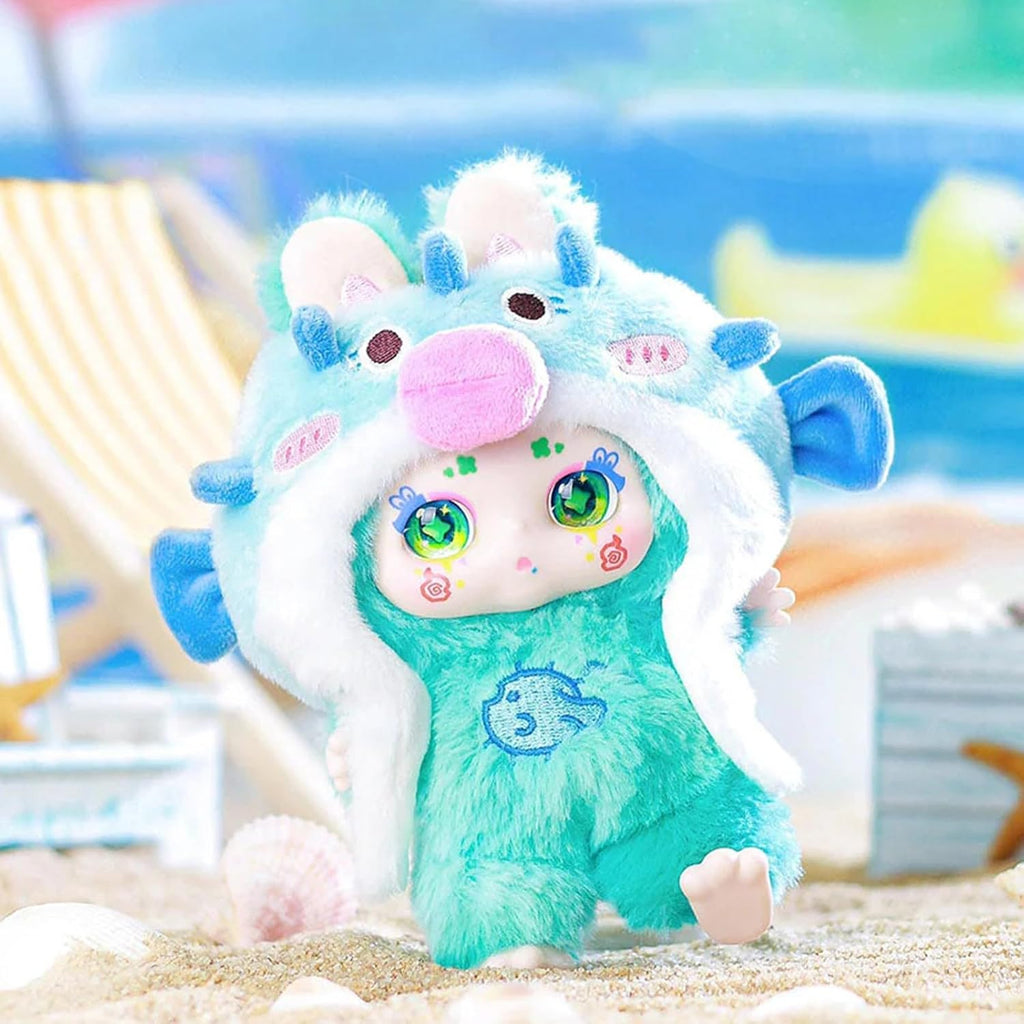 Colorful plush toy with a blue and white design on a sandy background