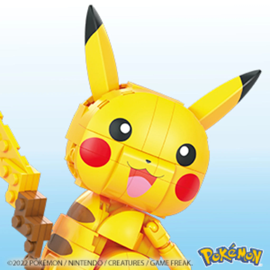 Toy figure of Pikachu from Pokémon on a light blue background