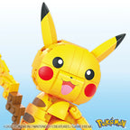 Toy figure of Pikachu from Pokémon on a light blue background