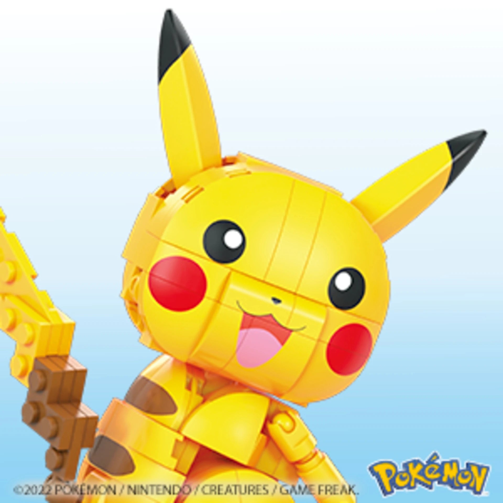 Toy figure of Pikachu from Pokémon on a light blue background