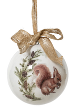 Decorative Christmas ornament with a squirrel and pinecones on a white background