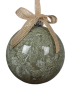 Decorative green ball ornament with pine branch pattern and brown ribbon on a white background