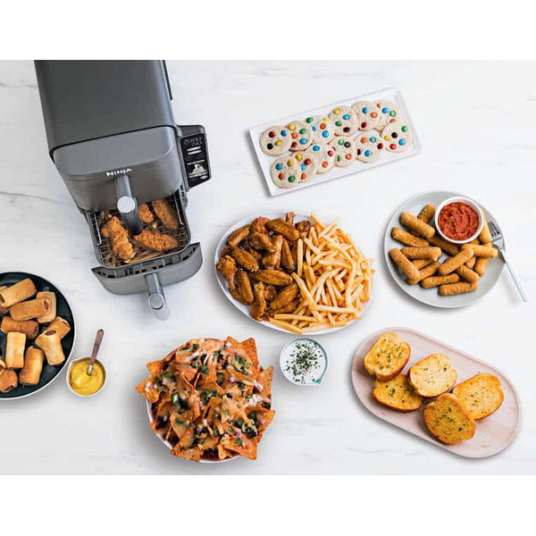 Ninja air fryer filled with roast chicken, chips,