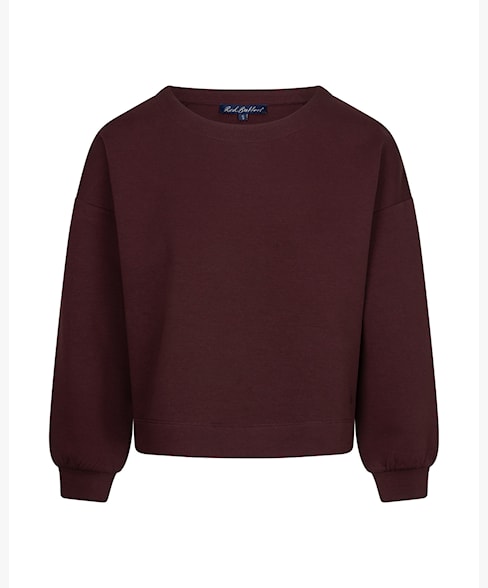 A dark burgundy crewneck sweatshirt with long sleeves and ribbed cuffs, displayed against a plain white background.