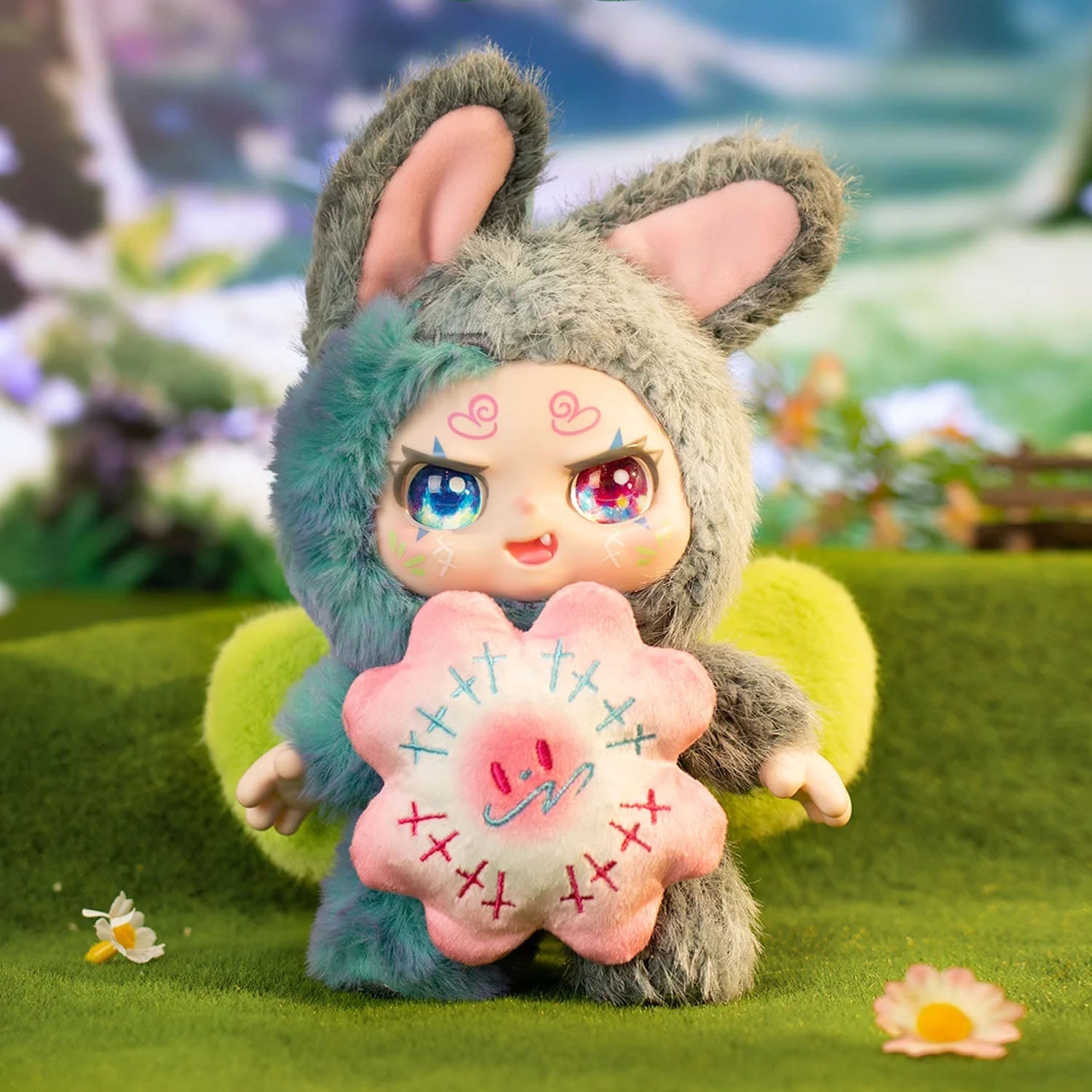 Toy figure with bunny ears holding a pink flower-like object on a grassy background