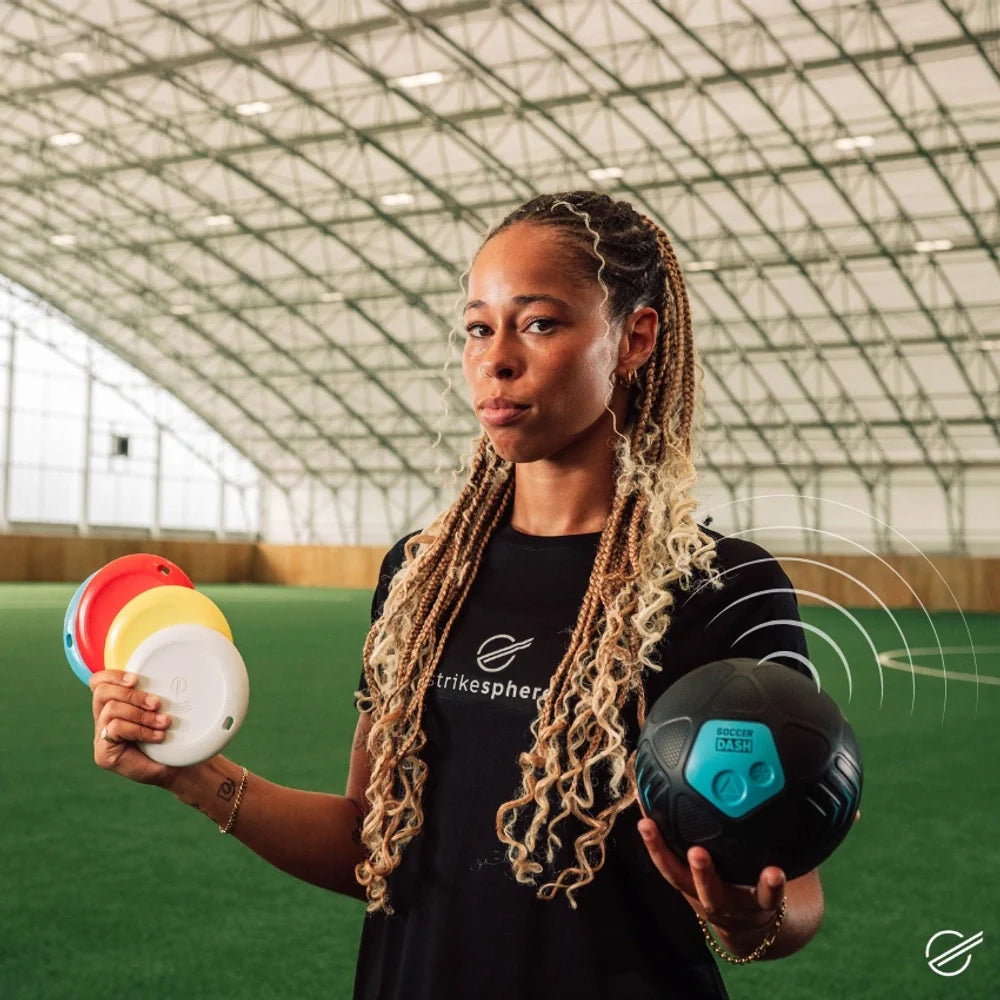 Person holding colorful balls in an indoor sports facility
