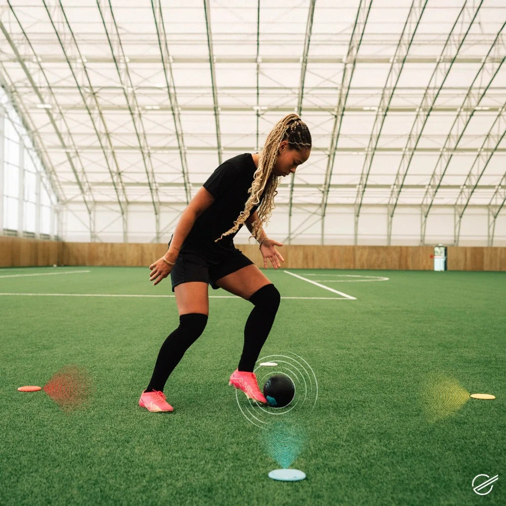 Person playing indoor sports with digital graphics on a green field