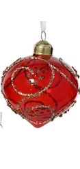 Red glass ornament with gold accents on a white background