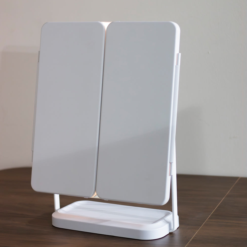 Hollywood Rechargeable Portable Mirror double-sided mirror on a wooden surface with a neutral background