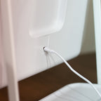 Close-up of aHollywood Rechargeable Portable Mirror with a usb attached for recharge, background view