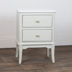 Monroe 2 Drawer Accent Table in Stonewith two drawers and gold knobs on a wooden floor.