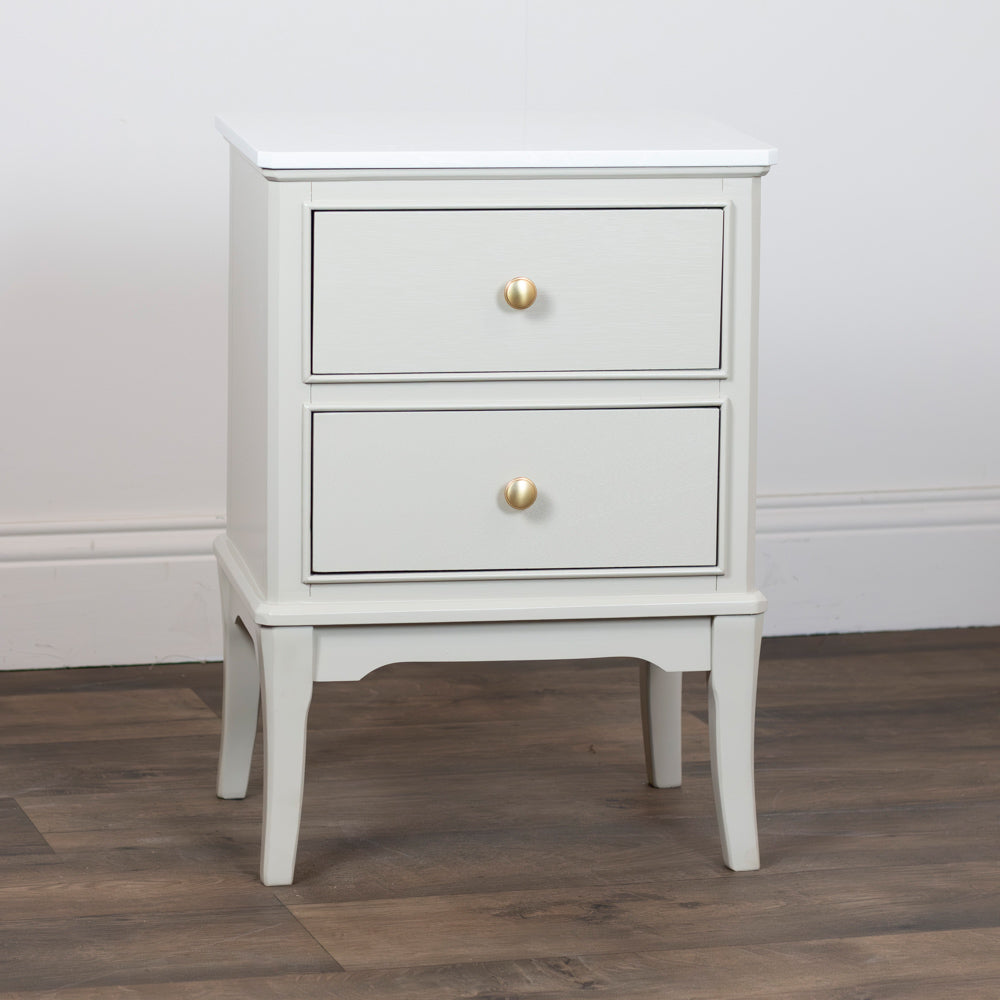 Monroe 2 Drawer Accent Table in Stonewith two drawers and gold knobs on a wooden floor.