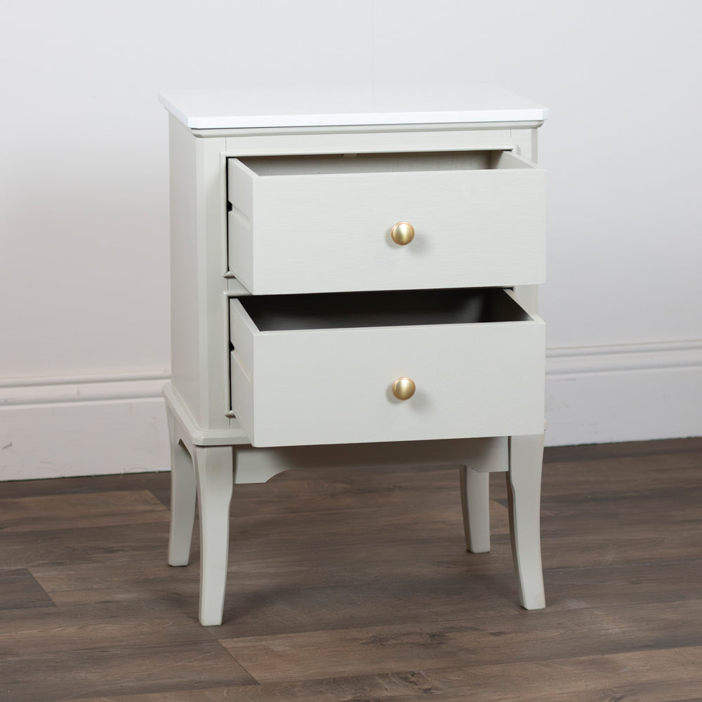 Monroe 2 Drawer Accent Table in Stonewith two drawers and gold knobs on a wooden floor.